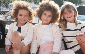 girls wearing minnow sweaters on boat